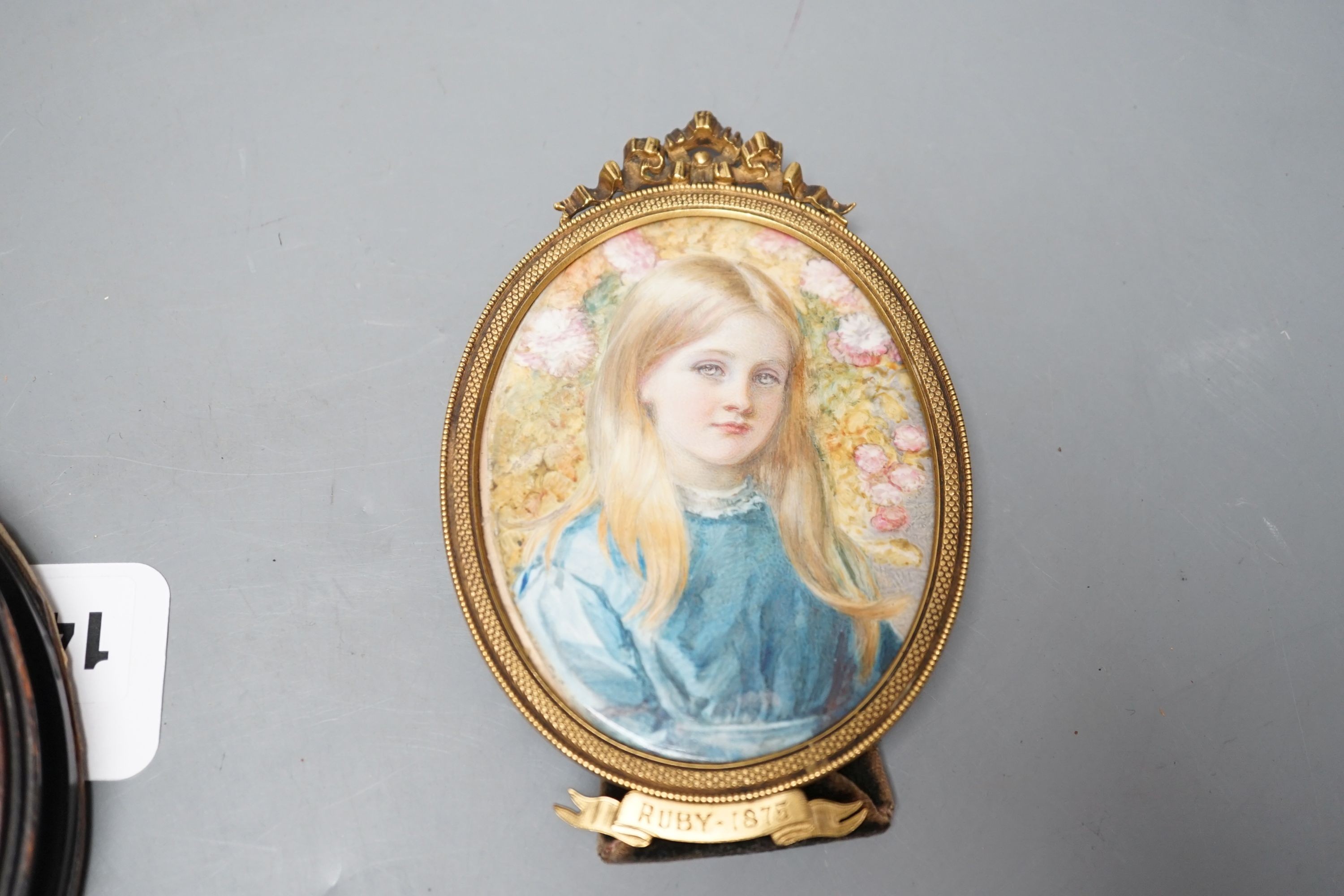 A late 19th century portrait miniature on ivory of a girl, ‘Ruby, 1875’, together with another (2)
